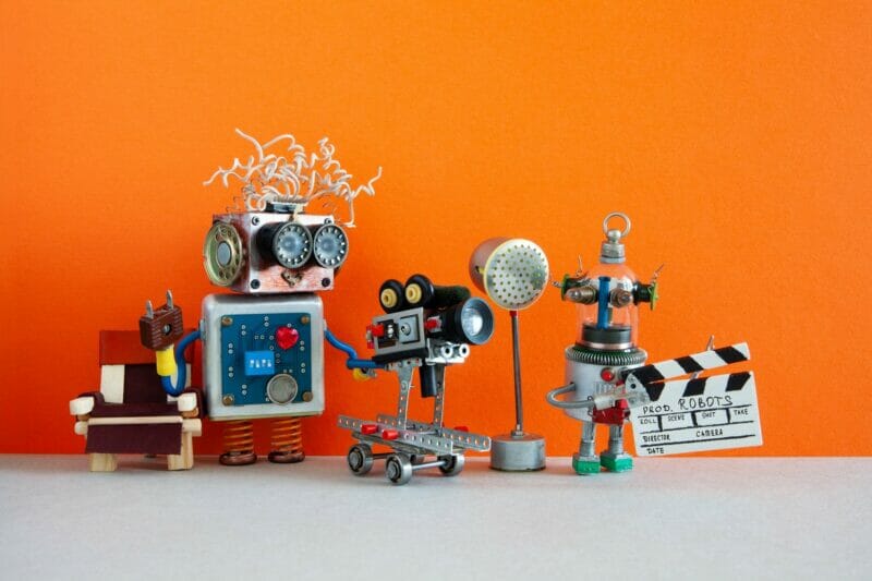 Robotic filmmaking backstage concept. Two robots shoots motion picture