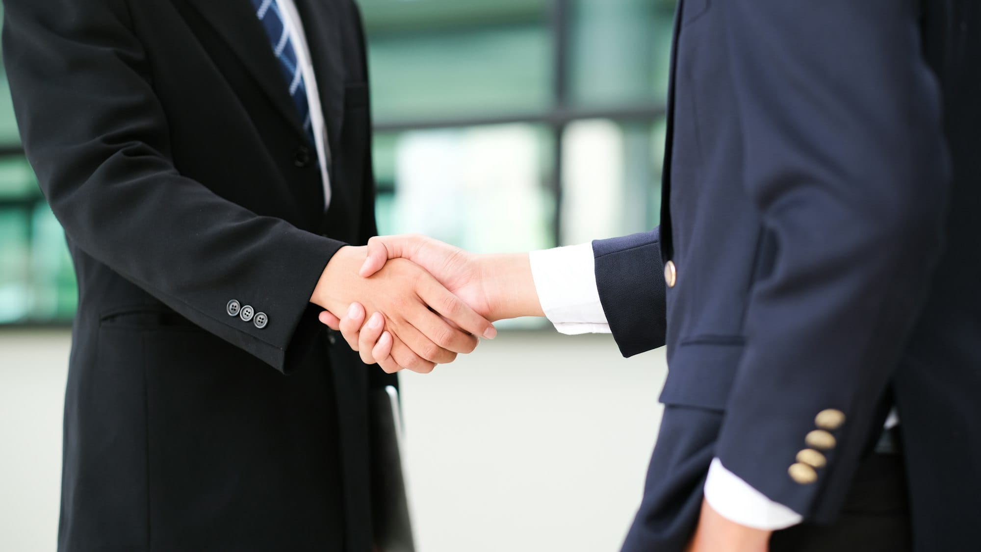 Businessmans handshake after good deal.
